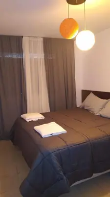 a bedroom with a bed with two towels on it at M65 Luxury Suit in Cordoba