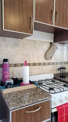 a kitchen with a stove and a counter top at Departamento Quirós in Cordoba