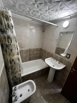 a bathroom with a sink and a tub and a toilet at San Lorenzo 137 in Cordoba