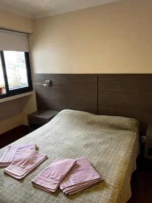 a bedroom with a bed with pink towels on it at San Lorenzo 137 in Cordoba