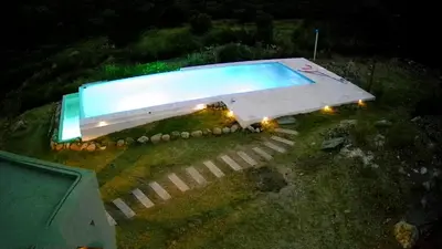 an overhead view of a swimming pool at night at La Deseada in Quines