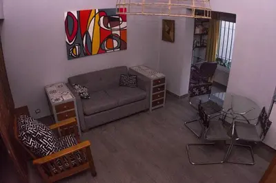 a living room with a couch and a painting on the wall at Monoambiente super funcional! in Cordoba
