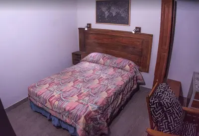 a bedroom with a bed with a wooden head board at Monoambiente super funcional! in Cordoba