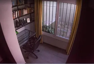 a room with a chair and a window and a book shelf at Monoambiente super funcional! in Cordoba