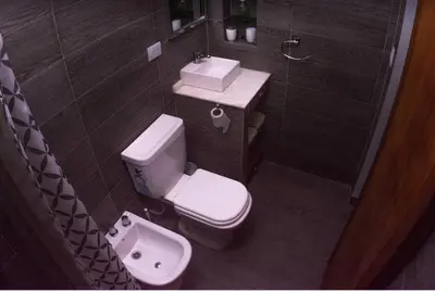 a bathroom with a white toilet and a sink at Monoambiente super funcional! in Cordoba
