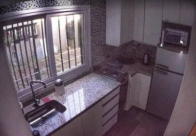 a small kitchen with a sink and a refrigerator at Monoambiente super funcional! in Cordoba