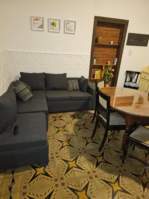 a living room with a couch and a table at Departamento Alta Gracia in Alta Gracia