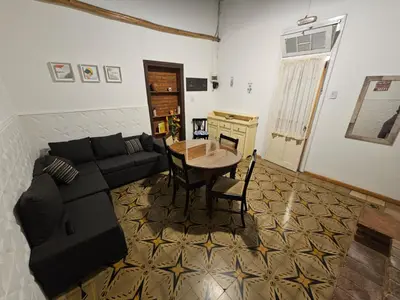 a living room with a couch and a table at Departamento Alta Gracia in Alta Gracia