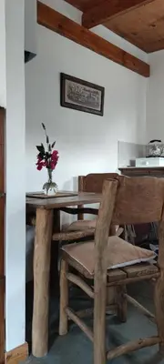 a dining room table with a vase of flowers on it at Los Ceibos Suites in Villa Ciudad de America