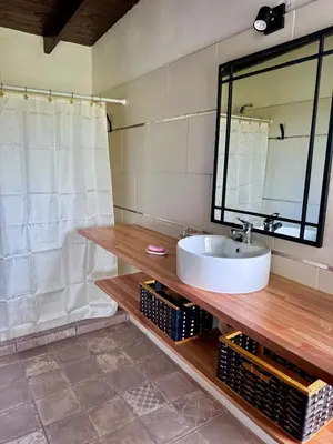 a bathroom with a sink and a large mirror at Cuatro Soles in Villa Yacanto