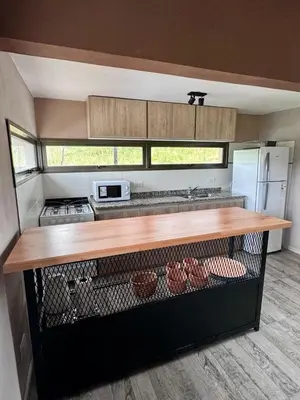 a kitchen with a counter and a counter top in a trailer at Cuatro Soles in Villa Yacanto