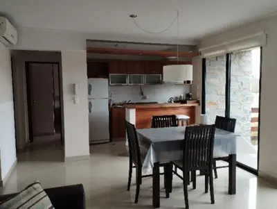 a kitchen and dining room with a table and chairs at Paraíso Serrano 17 in Villa Ciudad Parque