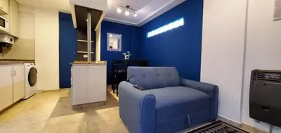 a blue room with a blue chair in a kitchen at Magestic Barrio General Paz in Cordoba