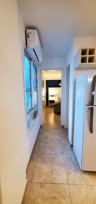 a hallway with a white refrigerator in a room at Magestic Barrio General Paz in Cordoba