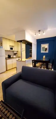 a living room with a couch and a kitchen at Magestic Barrio General Paz in Cordoba