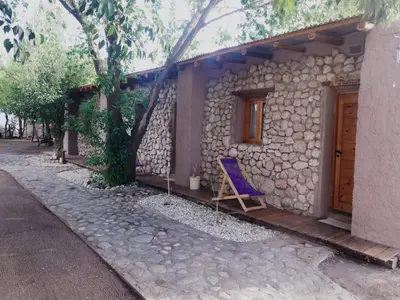 a blue chair sitting outside of a house at Las cuatro estaciones in Merlo