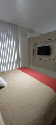 a bedroom with a large white bed with a flat screen tv at Apart Suite Premiun in Villa Carlos Paz