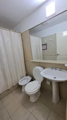 a bathroom with a toilet and a sink at Departamento -Obispo Salguero- Pleno Nueva Córdoba, cerca de Sanatorios, By Apartcba in Cordoba