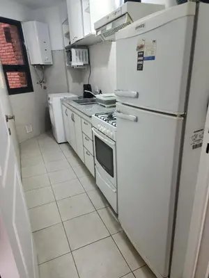 a kitchen with a white refrigerator and a stove at Departamento -Obispo Salguero- Pleno Nueva Córdoba, cerca de Sanatorios, By Apartcba in Cordoba