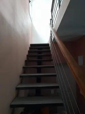 a staircase in a building with a light coming down at Apart Loma Linda in Merlo