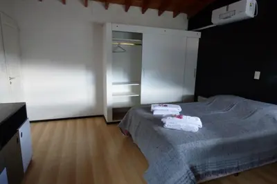a bedroom with a bed with two towels on it at Apart Loma Linda in Merlo