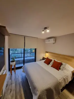 a bedroom with a large bed and a large window at Departamento Scala in Cordoba