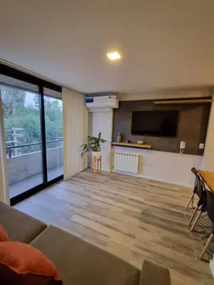 a living room with a couch and a flat screen tv at Departamento Scala in Cordoba