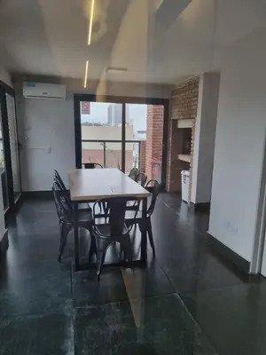 a dining room with a table and chairs in a room at Departamento Scala in Cordoba