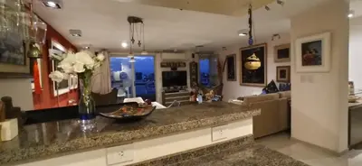 a kitchen with a counter with a vase of flowers at Fabuloso apartamento con terraza y asador propios in Cordoba