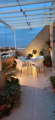 a patio with a table and chairs on a building at Fabuloso apartamento con terraza y asador propios in Cordoba