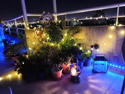 a child holding a light in a garden at night at Fabuloso apartamento con terraza y asador propios in Cordoba