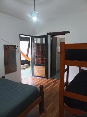 a bedroom with a bed and a sliding glass door at El kincho hostel bike in La Cruz
