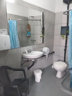 a bathroom with a sink and a toilet and a mirror at El kincho hostel bike in La Cruz