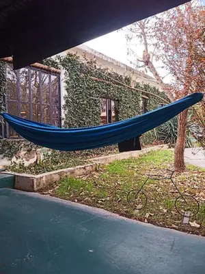 a blue hammock in front of a building at El kincho hostel bike in La Cruz