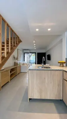 a kitchen with a sink and a staircase at Duplex en el Cerro de Las Rosas by Lugar in Cordoba