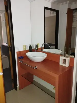 a bathroom with two sinks and a large mirror at Paraíso Serrano 16 in Villa Ciudad Parque