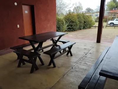 a picnic table and two benches on a patio at Paraíso Serrano 18 in Villa Ciudad Parque