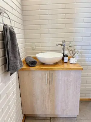 a bathroom with a bowl sink on a counter at Cabañas Amapolas Los Reartes in Los Reartes