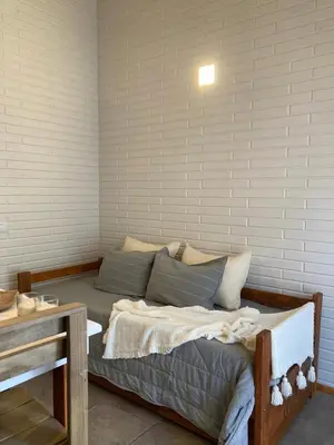 a bed sitting inside of a room with at Cabañas Amapolas Los Reartes in Los Reartes