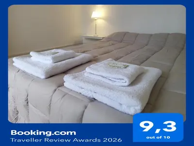 a bed with two white towels on top of it at Urquiza - Habitación para turistas in Cordoba