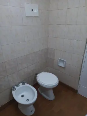 a bathroom with a toilet and a bidet at Urquiza - Habitación para turistas in Cordoba