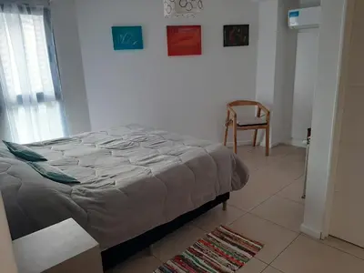 a bedroom with a bed and a chair in it at Sonoma Ribera 5D in Cordoba