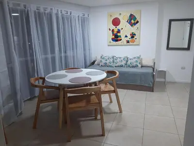 a living room with a table and chairs and a couch at Sonoma Ribera 5D in Cordoba