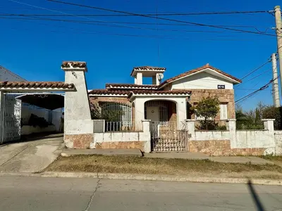 a house with a gate in front of it at La Soñada in Alta Gracia