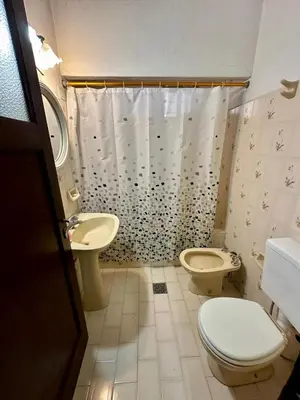 a bathroom with a toilet and a sink and a shower at La Soñada in Alta Gracia
