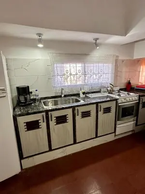 a kitchen with a sink and a stove at La Soñada in Alta Gracia