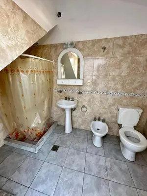 a bathroom with a sink and a toilet and a mirror at La Soñada in Alta Gracia