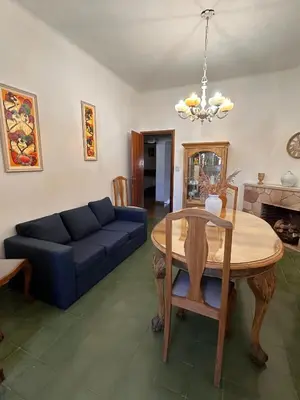 a living room with a blue couch and a table at La Soñada in Alta Gracia