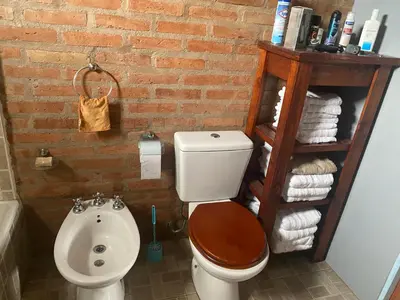 a bathroom with a toilet and a sink at La Herminda Casas de Campo in Nono