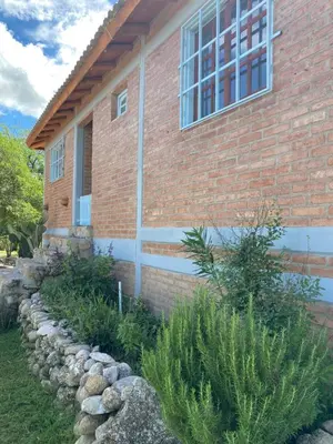 a brick house with a window on the side of it at La Herminda Casas de Campo in Nono